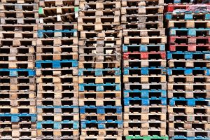 Abstract wooden pallets surface background, stack of pallet in warehouse, close up